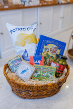 Load image into Gallery viewer, Basket with potato chips, books, and other items on a marble surface

